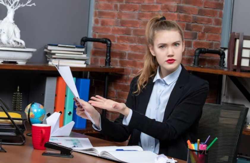 confused young lady in her office
