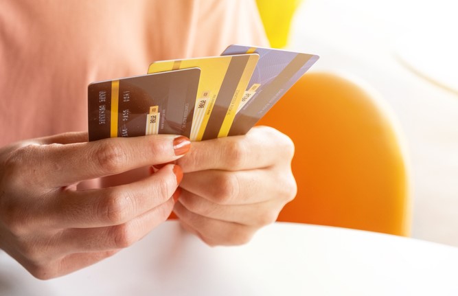 Woman's hands with several credit cards 
