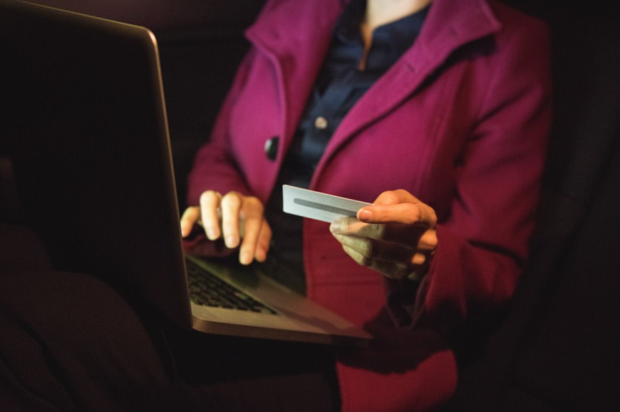 Businesswoman using laptop with credit card