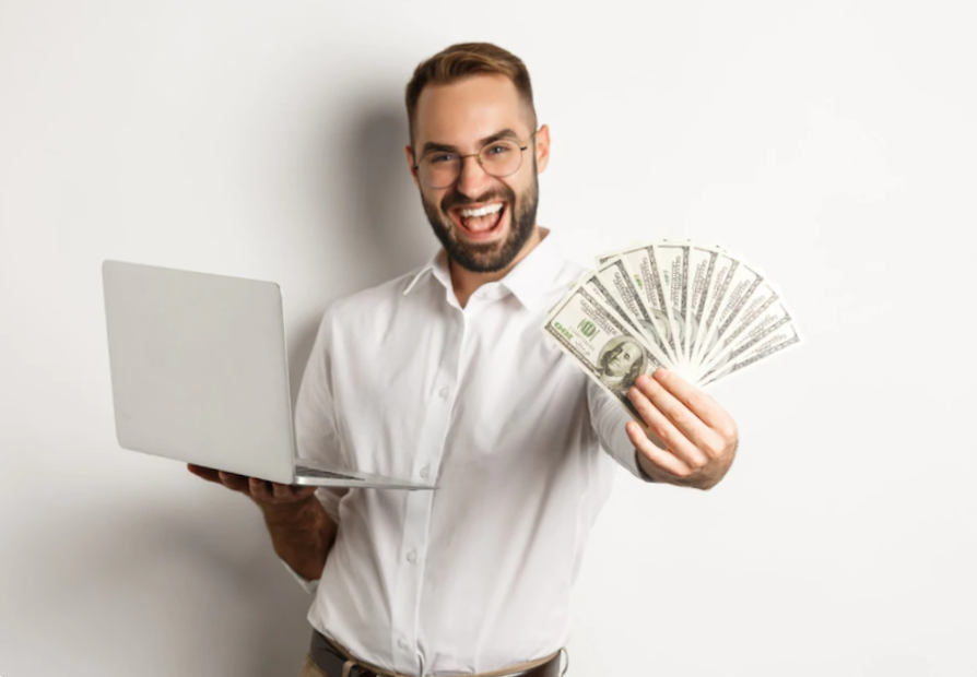 portrait man holding a laptop and doing a money fan