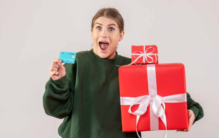 woman with xmas presents and bank card