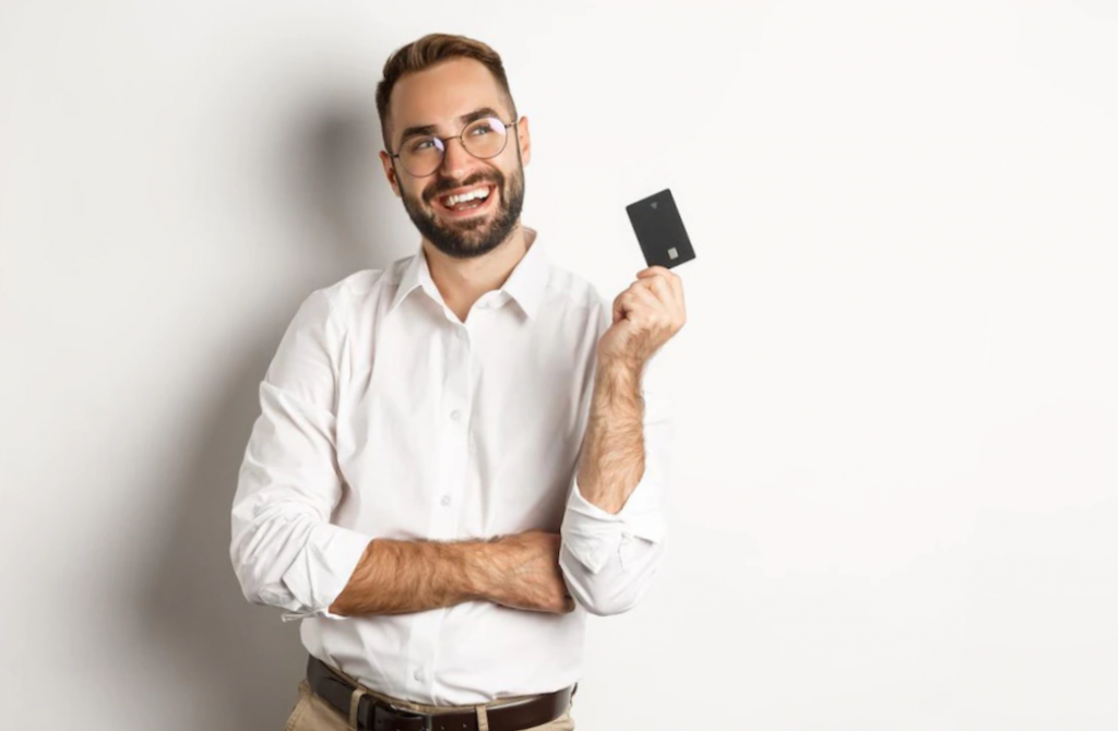 man holding credit card smiling and white background